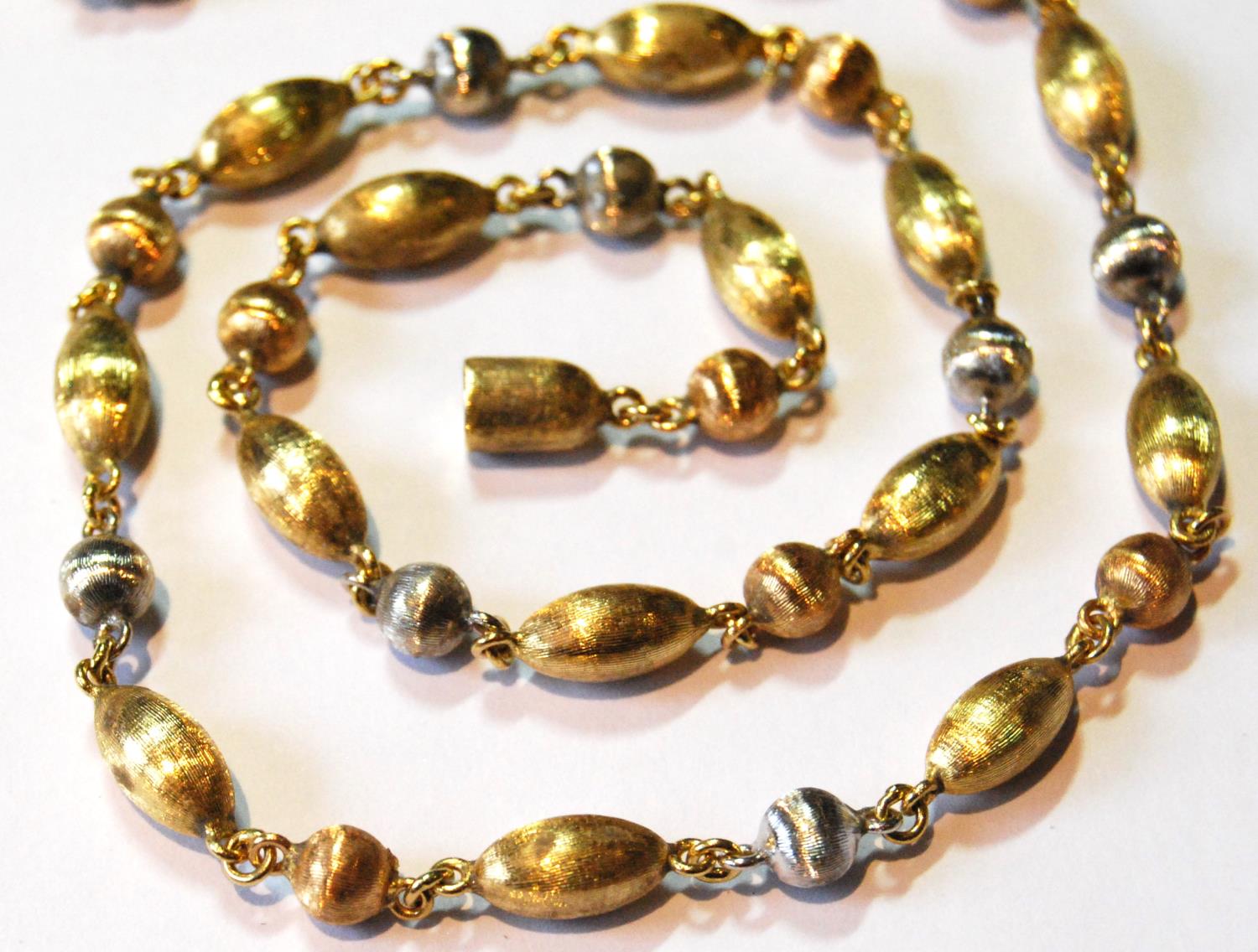 18ct coloured gold opera length necklace of textured oval and spherical beads, 31g. - Image 2 of 2