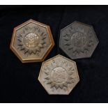 Three masonic wall plaques one mounted on wood depicting the square and compass in central medallion
