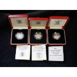 Three .925 silver British piedfort £1 coins with presentation boxes and papers. Dates to include;