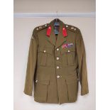 British Army uniform, an olive green jacket having Royal Artillery staybrite buttons, epaulette rank