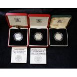 Three .925 silver British piedfort £1 coins two with presentation boxes and papers. Dates to