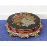 19th century oval carved gilt footstool, gros point needlework top, carved foliate scroll supports