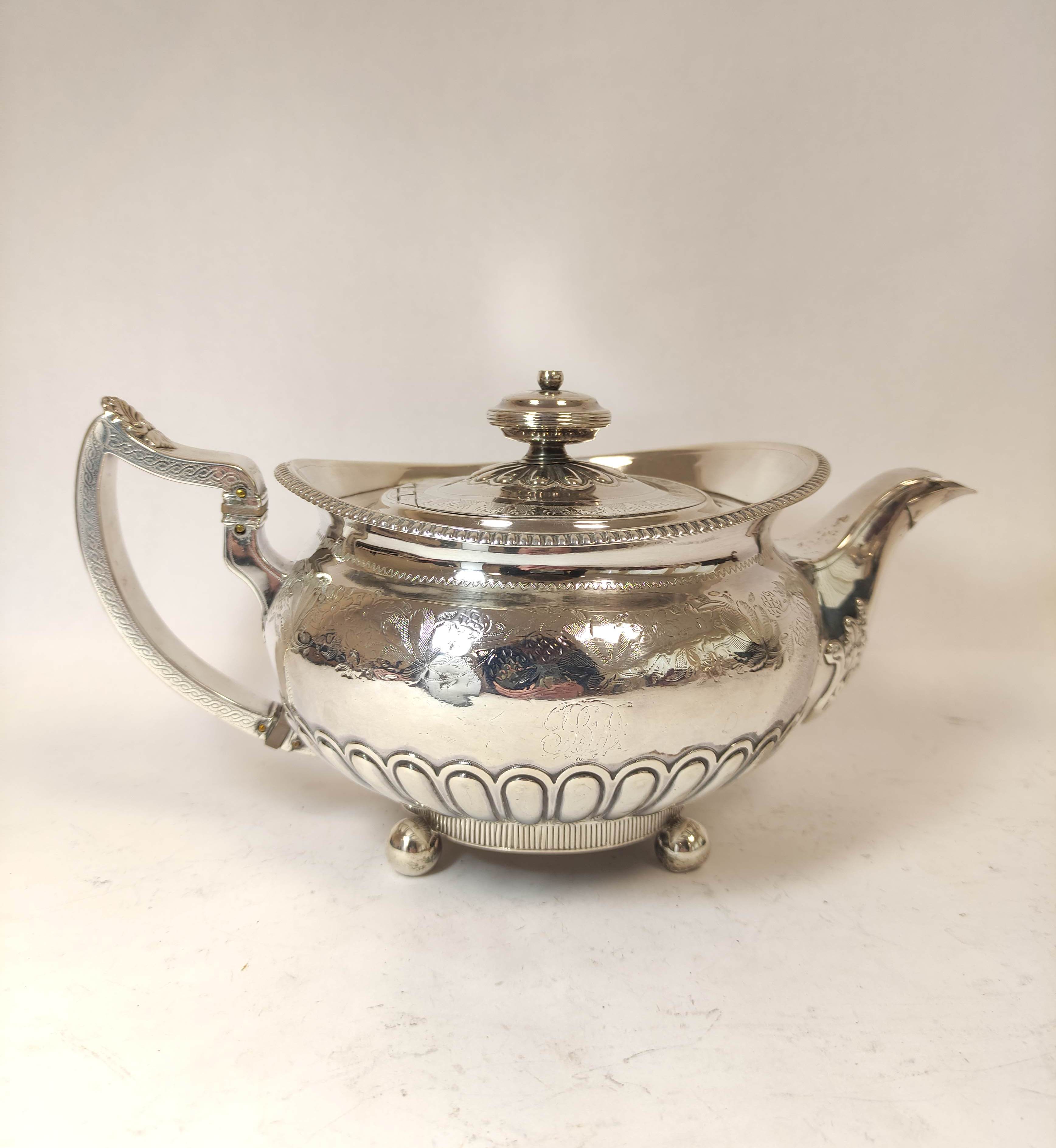 Silver tea pot of compressed spherical shape engraved and semi-gadrooned, by Robertson & Walton,