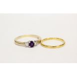 Diamond and amethyst three stone ring in 9ct gold, size R and a 22ct gold band ring, size L½, 2g.