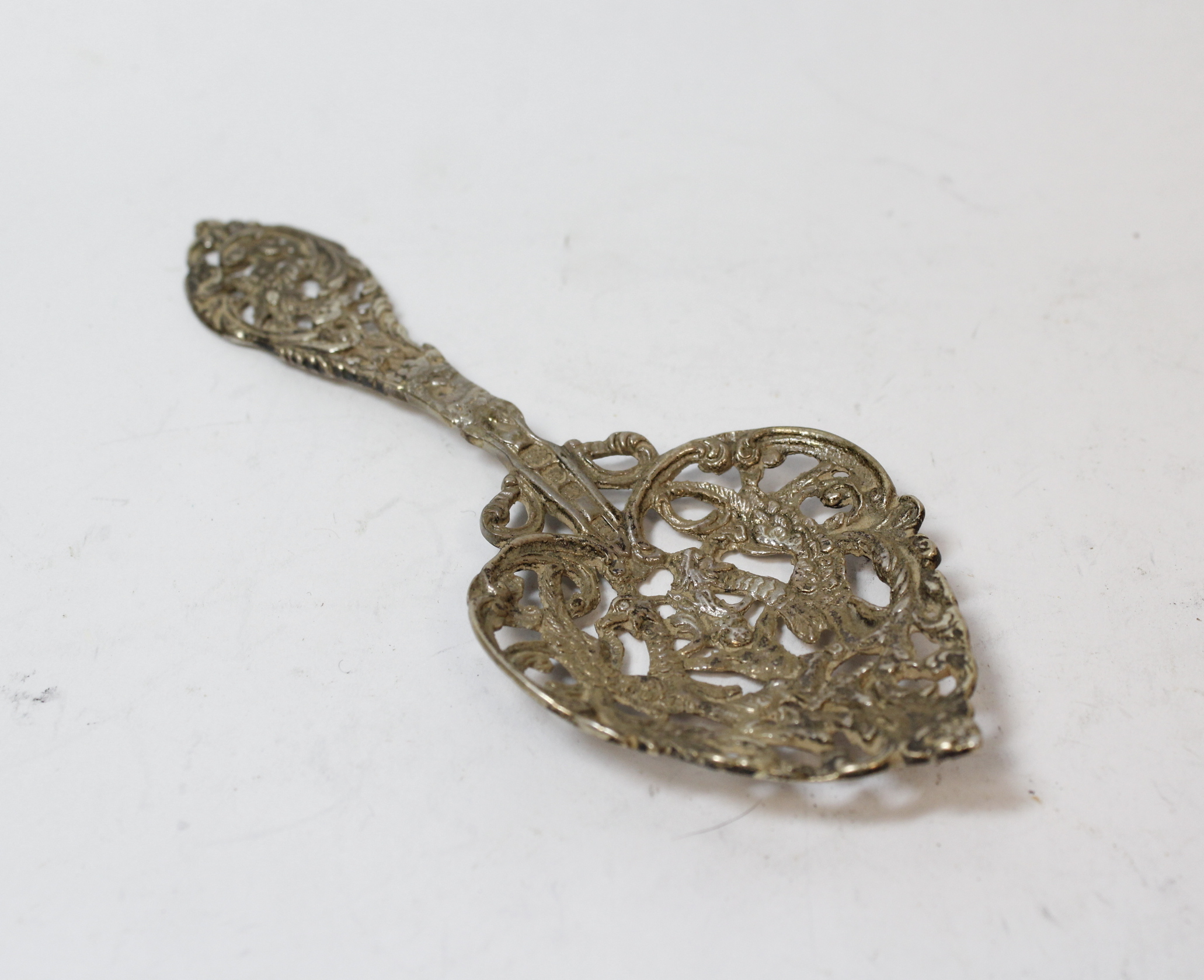 Silver ribbon puller modelled as a lion, 'fantasy' marks; two Chinese spoons and another, (London) - Image 3 of 4