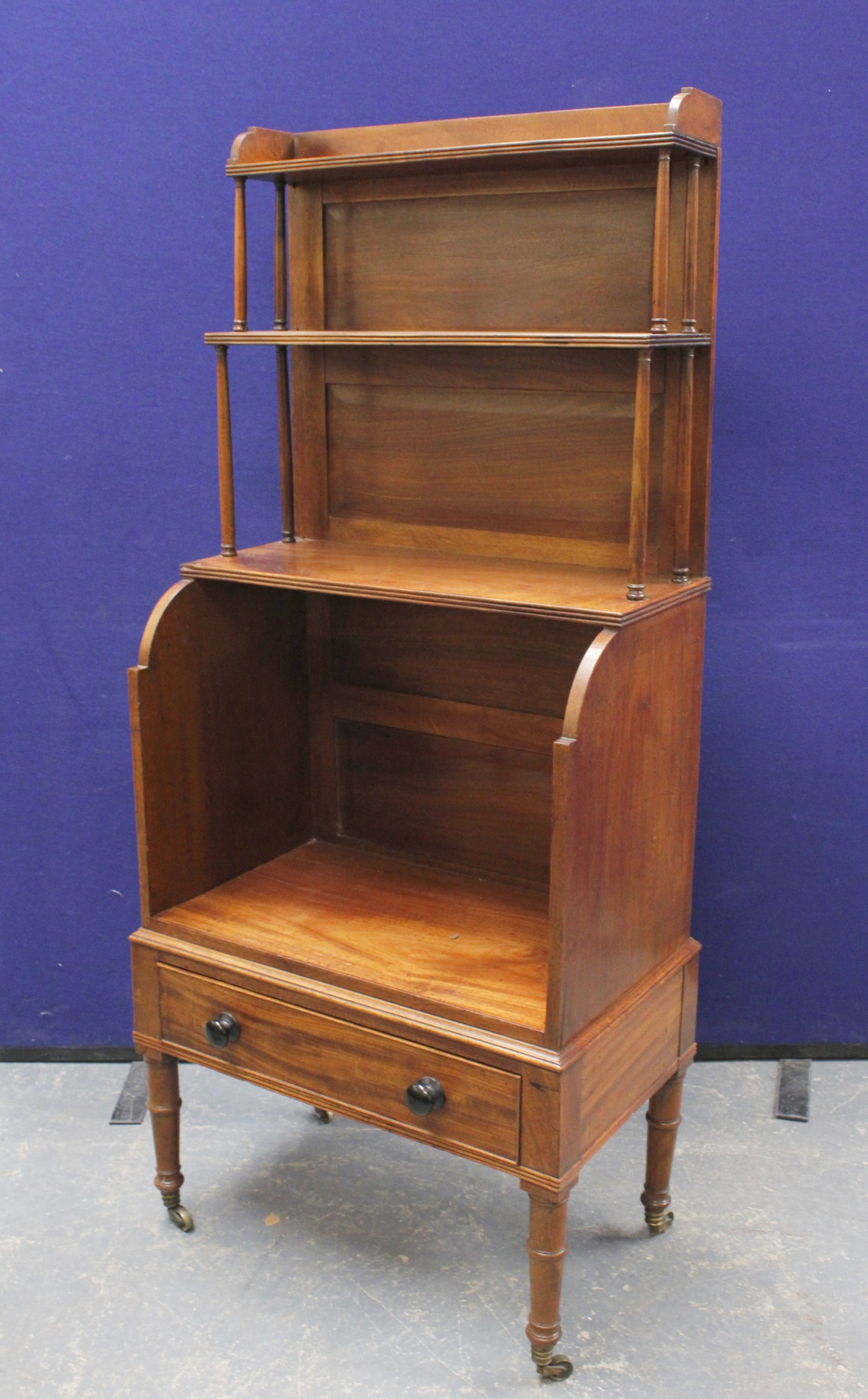 19th century mahogany three tiered stepped book case with base drawer, on turned supports. 143cm