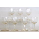 Set of seven small wine glasses, the rounded bowls on drawn stem and circular foot with engraved