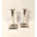 Pair of silver table candlesticks with plain cylindrical stems on stepped bases, Sheffield 1908,