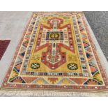 20th century Anatolian wool carpet with geometric design in predominantly red, yellow and blue,