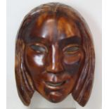 WILLI SOUKOP, R.A. (1907-95).  A carved wooden mask of a girl, signed and dated 1935, 24cm x 18cm.
