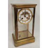 French four glass mantel clock with mercury pendulum and visible Brocot escapement in plain case.