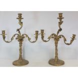 Pair of giltwood candelabra, each with three sconces on circular drip trays and scrolling foliate