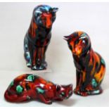 Two Anita Harris Studio Pottery figures of seated cats looking down, each 15cm high; also a figure