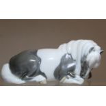 Danish Royal Copenhagen porcelain figure of a recumbent pony, no. 4611, with white and grey