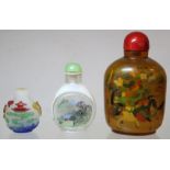Three Chinese snuff bottles: one of opaque white glass with carved polychrome overlay depicting