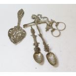 Silver ribbon puller modelled as a lion, 'fantasy' marks; two Chinese spoons and another, (London)