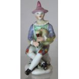 Mid 18th century Longton Hall porcelain "Commedia Dell'Arte" figure of Harlequin (Arlecchino) seated