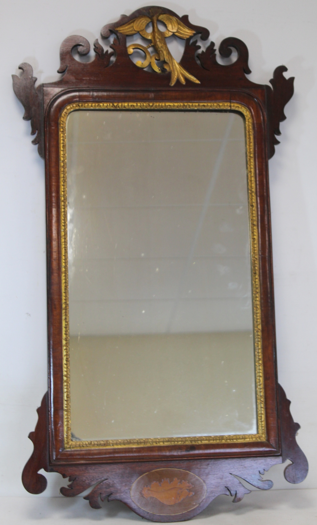 George III style mahogany wall mirror with fret cut frame, gilt slip and bird pediment and inlaid