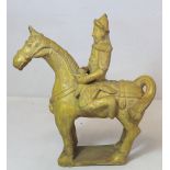 Chinese "Tang" pottery figure of a horse and rider with yellow ochre glaze, 22cm high.