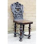 19th century hall chair the carved back with open mouth flanked by swan ornaments, solid seat on