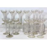 Set of eight clear glass ale or toasting flutes, the pan topped faceted trumpet bowls on knopped