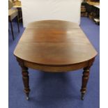 19th century mahogany dining table with curved D ends and centre leaf raised on turned baluster