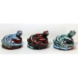 Three Anita Harris Studio Pottery figures of lizards, coiled, on naturalistic plinth base with