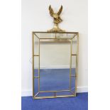 Gilt wall mirror with eagle finial surmount over central rectangular plate flanked by ten smaller