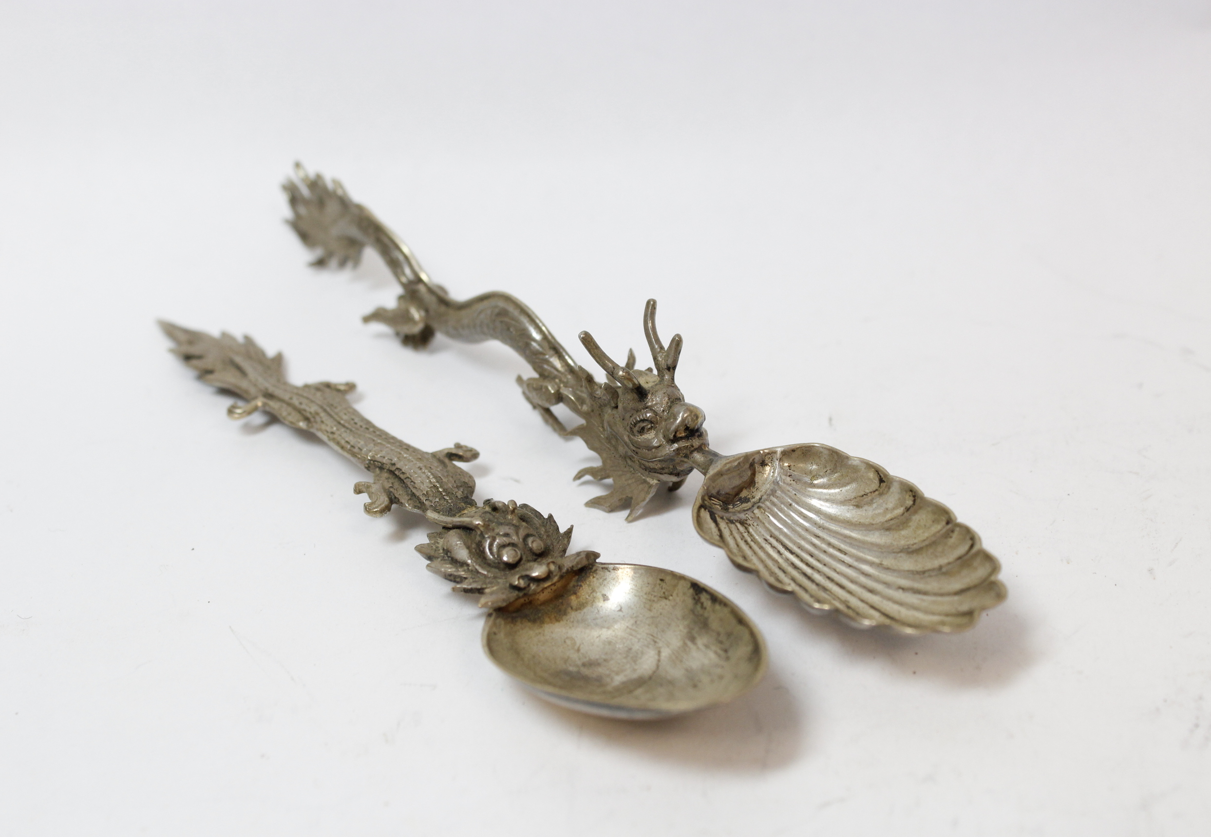 Silver ribbon puller modelled as a lion, 'fantasy' marks; two Chinese spoons and another, (London) - Image 2 of 4