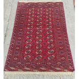 Early 20th century red Turcoman rug, c.1920's, with three rows of twelve guls, 175cm x 118cm.