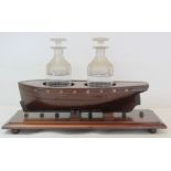 19th century mahogany novelty decanter stand in the form of a boat with two circular apertures