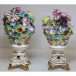 Pair of 19th century Derby style ornaments in the form of vases of flowers decorated in polychrome
