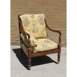 Regency mahogany framed library chair, the scroll arms on hexagonal turned columns raised on