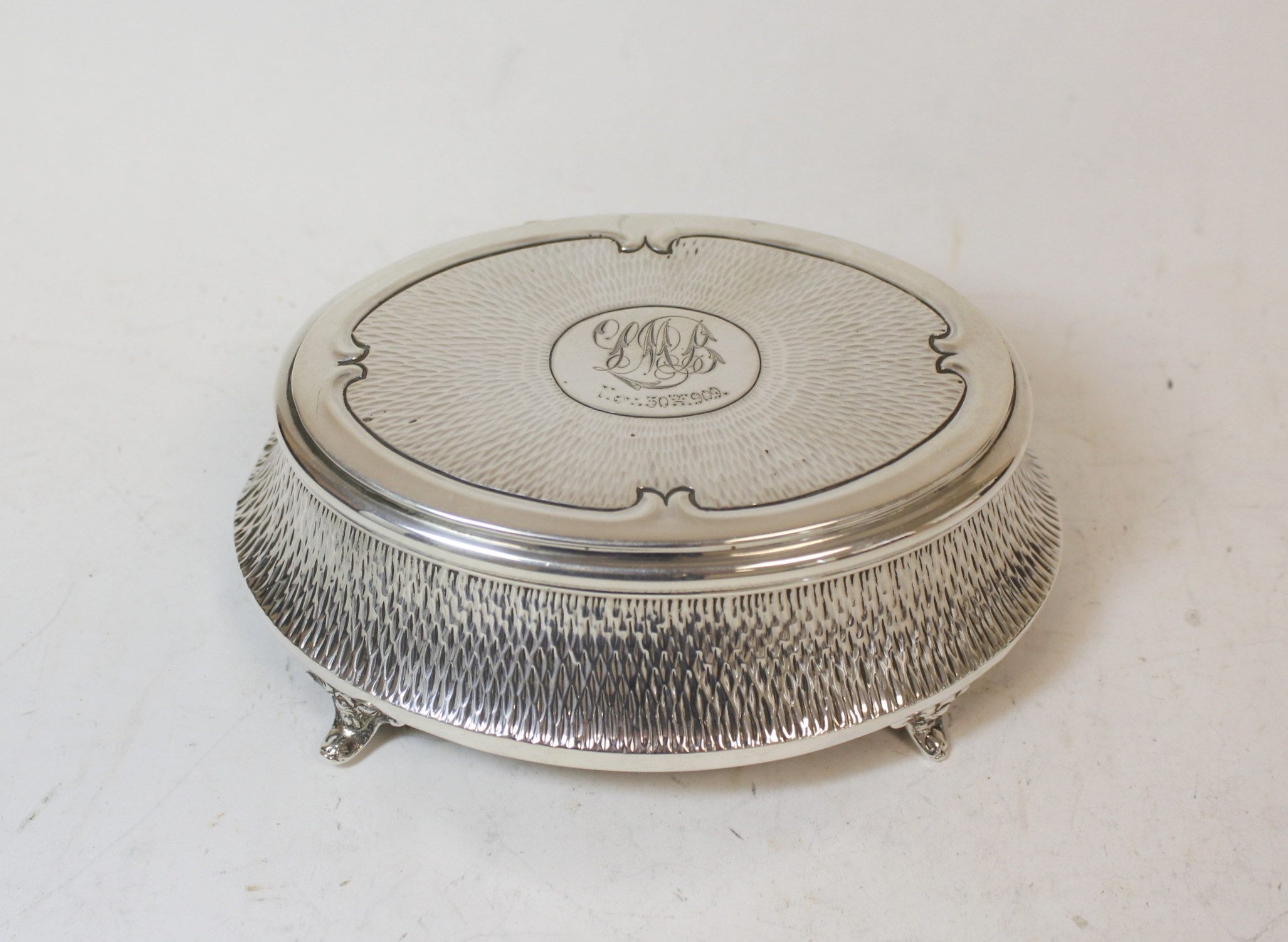 Silver oval bijouterie box, hammered, monogramed and dated 1909, by Zimmermans, Birmingham 1908.