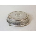 Silver oval bijouterie box, hammered, monogramed and dated 1909, by Zimmermans, Birmingham 1908.