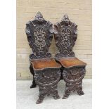 Pair of 19th century Italian Sgabello carved walnut hall chairs,profusely pierced & carved, each