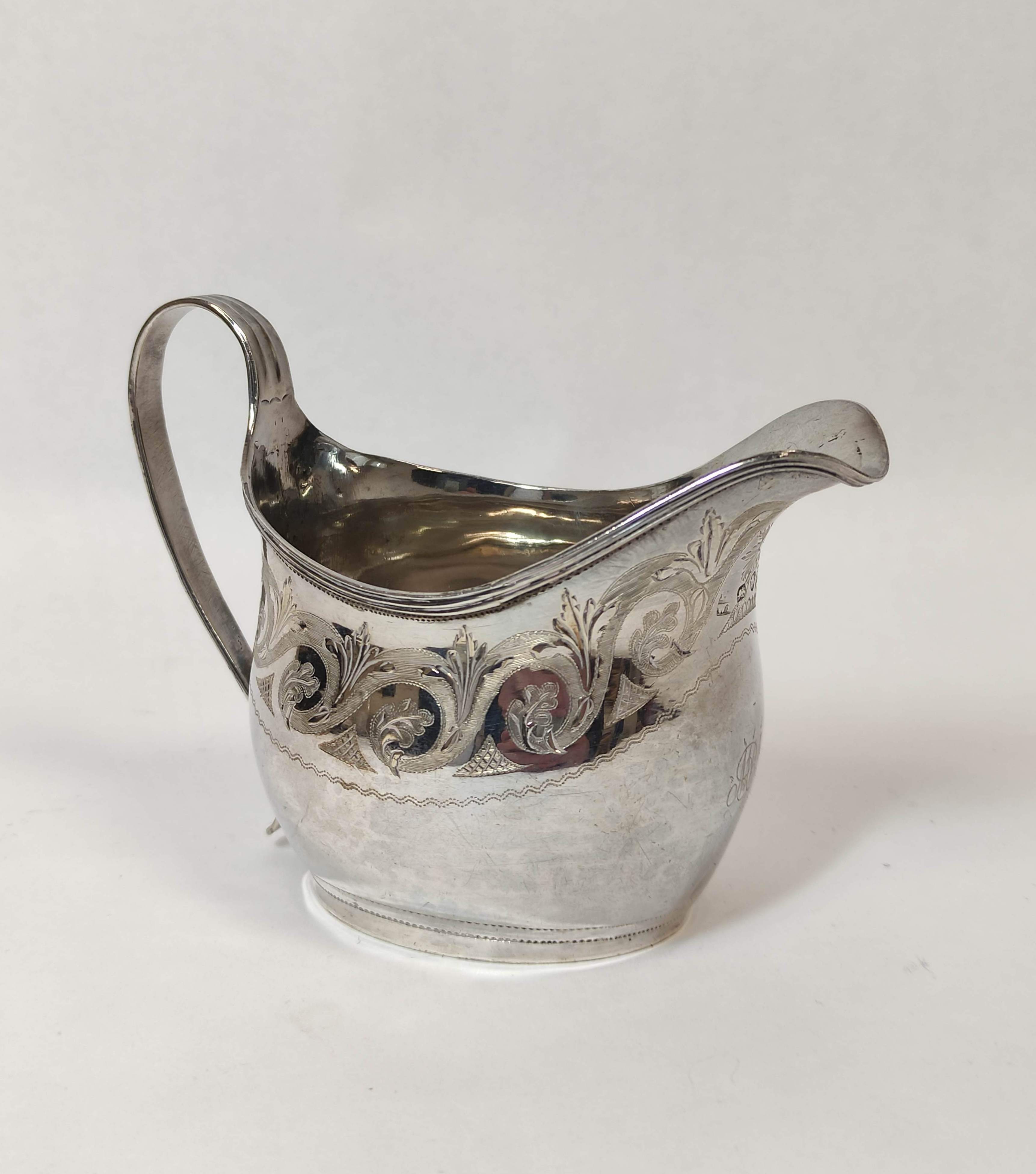 Silver cream jug of ovoid shape engraved with scrolls by P & W Bateman, 1812, 93g.