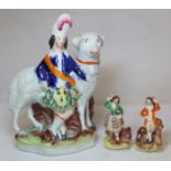 Staffordshire flatback figure of a kilted boy standing beside a large sheep, decorated in