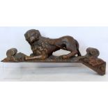 Antique carved oak figure of a crouching lion on naturalistic shaped base with scrolls to either