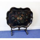 Victorian black papier mache tray of shaped outline decorated with parrots among flowers, raised