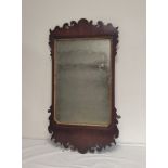 George III walnut framed fret wall mirror with bevelled edge plate, gilt slip. 82cm
