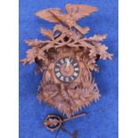 Early 20th century Black Forest cuckoo clock with brass movement in carved case of typical style,