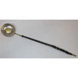 Silver toddy ladle with baleen handle and inserted Charles I gold crown coin.
