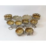 Collection of eight Indian embossed silver dishes, some on cobra supports and two similar salts.  (