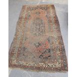 Persian wool carpet in predominantly red and blue with central floral lozenge medallion. 326cm x