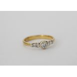 Diamond ring with chamfered square brilliant and kite shoulders, in 18ct gold, size O.