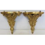 Pair of giltwood foliate scroll wall brackets with lobed trefoil tops, each 37cm high, 33cm