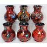 Six Anita Harris Studio Pottery "Trojan" vases decorated with "Potteries Past" pattern, flowers