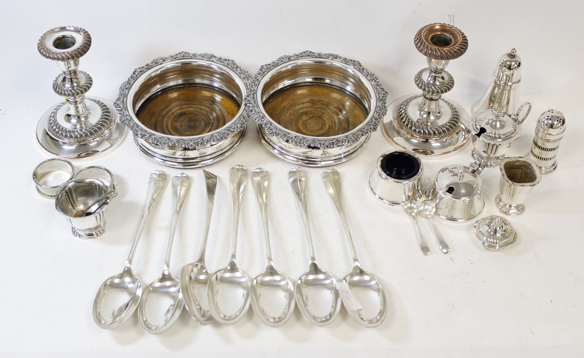 Pair of Sheffield decanter stands, a pair of similar candlesticks, seven soup spoons, two napkin