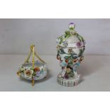 Continental porcelain pot pourri vase of ovoid form on three scroll supports and circular plinth